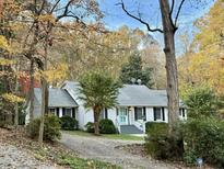 Charming single-story home with painted brick, lovely landscaping, and a welcoming light blue front door at 325 Old Salem Rd, Roxboro, NC 27573