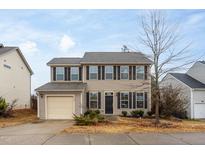 Charming two-story home featuring a well-maintained yard and an attached garage at 3429 Ferdilah Ln, Raleigh, NC 27610