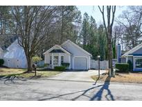 Charming single-story home with gray siding and a well-manicured lawn and a paved driveway at 5108 Gable Ridge Dr, Durham, NC 27713
