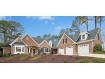 Charming brick home with a well-manicured front yard and a spacious three-car garage at 5204 Winter Holly Ct, Raleigh, NC 27606