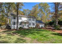 Charming two-story home with a lush lawn and mature trees at 100 Queensferry Rd, Cary, NC 27511