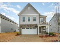 Charming two-story home with stone accents and attached two-car garage at 1016 Matterhorn Dr, Fuquay Varina, NC 27526