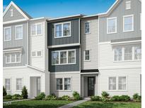New townhouse boasts a modern facade, neutral palette, and manicured lawn at 1033 Zelkova Lane, Chapel Hill, NC 27517