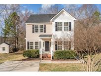 Charming two-story home with a welcoming front porch and well-maintained landscaping in a suburban setting at 105 Caribbean Ct, Knightdale, NC 27545