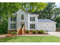 Charming two-story home with a manicured lawn, enhanced by tasteful landscaping and a two-car garage at 112 Ridgepath Way, Cary, NC 27511