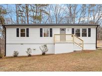 Charming single-story home with black shutters and newly renovated wooden porch and stairs at 120 King Charles Rd, Hillsborough, NC 27278