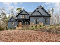 Stunning two-story home featuring stone accents, a covered porch, and professional landscaping at 148 Evington Dr, Pittsboro, NC 27312