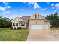 Charming brick home with a well-manicured lawn and attached two car garage at 151 Becky Ln, Princeton, NC 27569