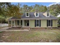 Charming exterior elevation with dormer windows and a cozy covered porch, offering great curb appeal at 1512 Maybrook Dr, Raleigh, NC 27610