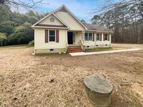 Charming single-story home with a cozy front yard and beautiful exterior details at 1515 Indian Camp Rd, Chapel Hill, NC 27516