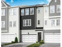 Charming townhome featuring a modern design with a two-car garage and a mix of white and dark gray siding at 2019 Trident Maple Ln, Chapel Hill, NC 27517