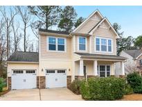 Charming two-story home featuring a two-car garage and inviting front porch, perfect for a Gathering at 211 Court Jester Way, Morrisville, NC 27560