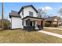 Charming two-story home with a classic white exterior, black trim, and inviting front porch at 405 N Hyde Park Ave, Durham, NC 27703