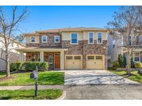 Charming two-story home boasts a stone facade, multi-car garage, and well-manicured lawn in a desirable neighborhood at 532 Front Ridge Dr, Cary, NC 27519