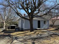Charming single-story home with light blue siding and a beautiful tree in the front yard at 630 North Ave, Burlington, NC 27217