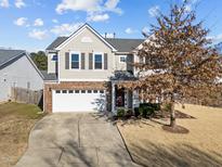 Traditional two-story home featuring a two-car garage and a well-manicured lawn at 1510 Roaring Rapids Rd, Raleigh, NC 27610