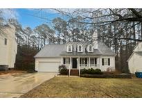 Charming one-story home featuring a welcoming front porch, dormer windows and attached garage at 206 Collegiate Cir, Durham, NC 27713