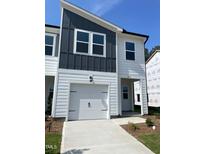 Charming townhome features a one-car garage and modern architectural details at 3019 Vitner Dr, Durham, NC 27704