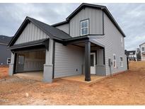 Two-story home featuring a two-car garage, a covered entry, and gray siding with black trim at 4309 Darius Ln # 26, Fuquay Varina, NC 27526