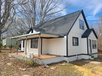 Charming exterior elevation featuring a covered porch and white siding with black trim at 527 Cornelius, Hillsborough, NC 27278