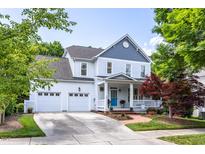 Charming two-story home with a welcoming front porch, landscaped yard, and a two car garage at 109 Parkridge Ave, Chapel Hill, NC 27517