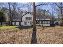 Charming two-story home with a distinctive black-and-white design and a beautifully landscaped front yard at 14115 Allison Dr, Raleigh, NC 27615