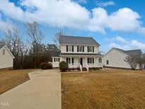 Charming two-story home with a welcoming front porch and well-maintained lawn at 1599 Rogers Pointe Ln, Creedmoor, NC 27522