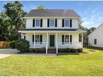 Charming two-story home featuring a welcoming front porch and well-manicured lawn at 1599 Rogers Pointe Ln, Creedmoor, NC 27522