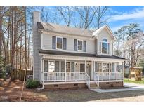 Charming two-story home featuring a welcoming front porch and classic architectural details at 209 Hutchins Dr, Garner, NC 27529