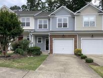 Charming townhome featuring a one car garage, complemented by tasteful landscaping and curb appeal at 2114 Stoney Spring Dr, Raleigh, NC 27610