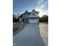 Beautiful two-story home showcasing a modern exterior with a spacious driveway and ample natural light at 5705 Flowery Meadow Ct, Wake Forest, NC 27587