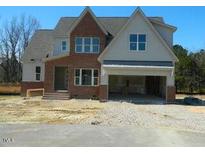Charming two-story home with a brick and gray facade and a spacious two-car garage at 5705 Flowery Meadow Ct, Wake Forest, NC 27587