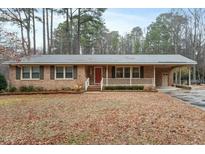 Charming brick home with a covered porch and a well-maintained front yard at 628 Stratford Dr, Zebulon, NC 27597