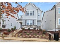 Charming two-story home featuring stone accents and landscaped front yard at 6509 Archwood Ave, Raleigh, NC 27616