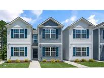 Charming two-story homes featuring vinyl siding, bright windows and professionally landscaped front yard at 8643 Brixton Shay Dr, Raleigh, NC 27616
