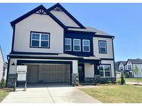 A beautiful two-story home with a 2-car garage, black trim, stone accents, and a well-manicured lawn at 100 N Stonemill Trl # Homesite 252, Wilson's Mills, NC 27520