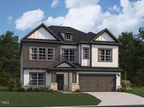 Two story home with gray trim, a large garage, and a covered front porch at 1404 Malcus Ct # 56, Fuquay Varina, NC 27526