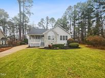 Charming single-story home with well-manicured lawn and inviting front porch at 1419 Mangum Ave, Creedmoor, NC 27522