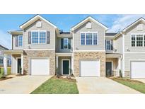 Charming townhomes feature stone accents and private garage entries at 1909 Frost Dr, Haw River, NC 27258