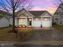 Charming single-story home featuring a two-car garage and a well-manicured front lawn at 2815 Mebane Ln, Durham, NC 27703