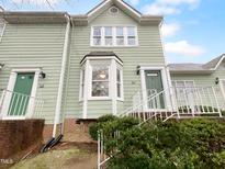 Charming multi-story townhouse with light green siding and updated windows at 516 Caprice Ct, Raleigh, NC 27606