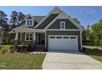 Charming one-story home with a two-car garage, covered porch and landscaped front yard at 5849 Genesee Dr., Homesite 3, Durham, NC 27712