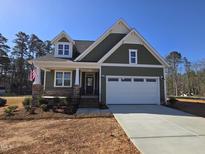 New construction, two-story home with stone accents, covered porch, and a two car garage at 5849 Genesee Dr., Homesite 3, Durham, NC 27712