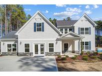 Charming two-story home with attractive gray siding, beautiful landscaping, and a welcoming front entrance at 67 Rice Road # 01, Zebulon, NC 27597