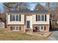 Charming two-story home featuring a brick foundation and classic black shutters at 7 Misty Creek Ct, Durham, NC 27705