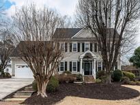 Charming two-story home featuring a well-maintained lawn, inviting entrance, and attached two car garage at 704 Tranter Dr, Apex, NC 27502