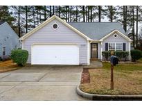 Charming single-story home features a two-car garage, well-manicured lawn, and attractive landscaping at 709 Averroe Dr, Apex, NC 27502
