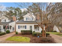 Charming two-story home with light siding, blue shutters, and a well-manicured front yard at 800 Mill Greens Ct, Raleigh, NC 27609