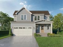 Charming two-story home featuring a two-car garage, complemented by a well-manicured lawn and colorful flowerbeds at Lot 12 Grayhaven Pl, Raleigh, NC 27606
