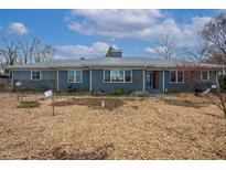 Charming single-story home with a manicured front yard and inviting blue facade at 1005 W Club Blvd, Durham, NC 27701